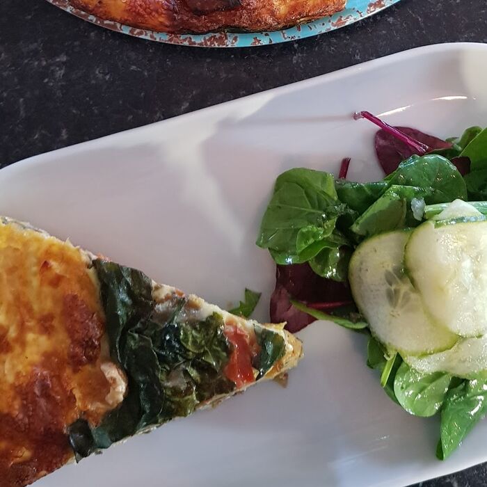 A sliced frittata on a turquoise plate