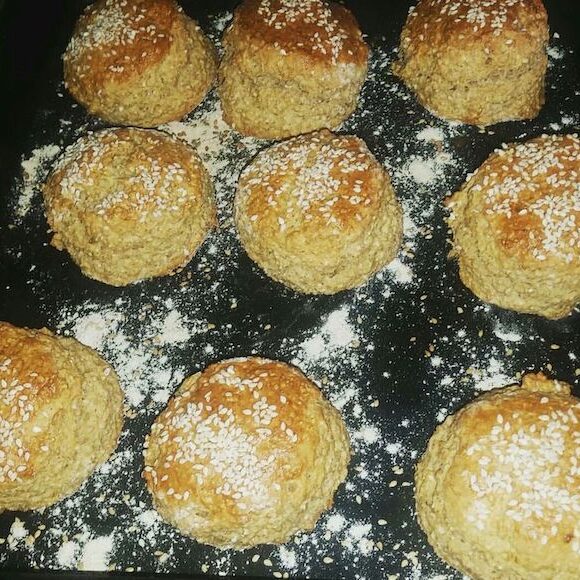 Multi-seed scones with sesame seeds on a baking tray