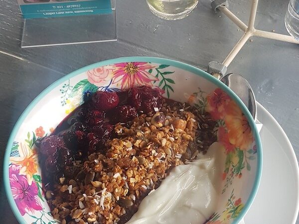 A bowl of granola with berry compote and yogurt